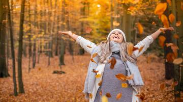Junge Frau in Laubwald im Herbst 